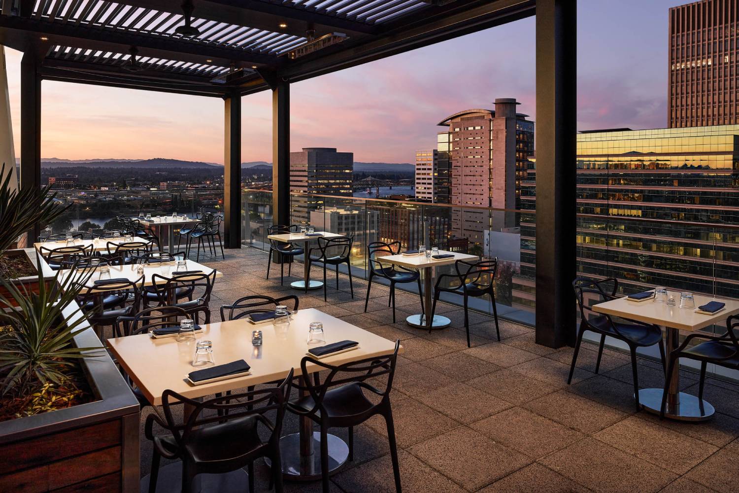 Depatures-East-Patio-Twilight tables and chairs out on a deck