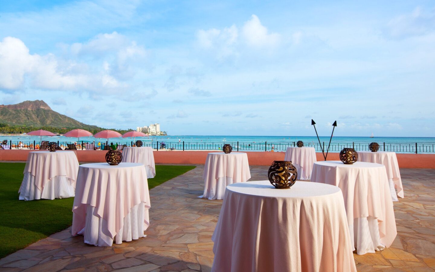 pink tables with ocean view in the background