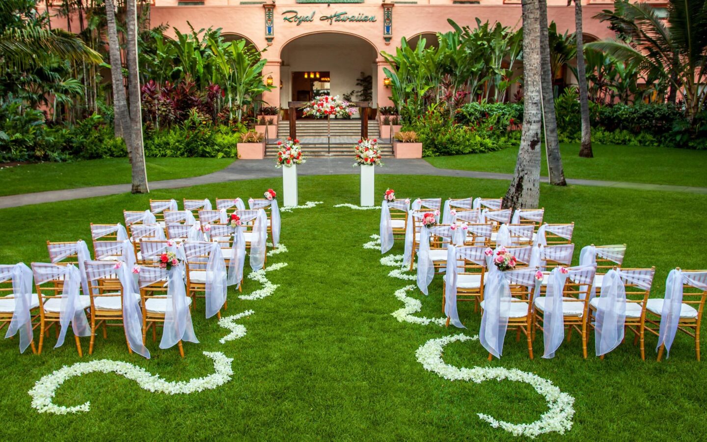brown wooden white padded chairs during daytime for wedding