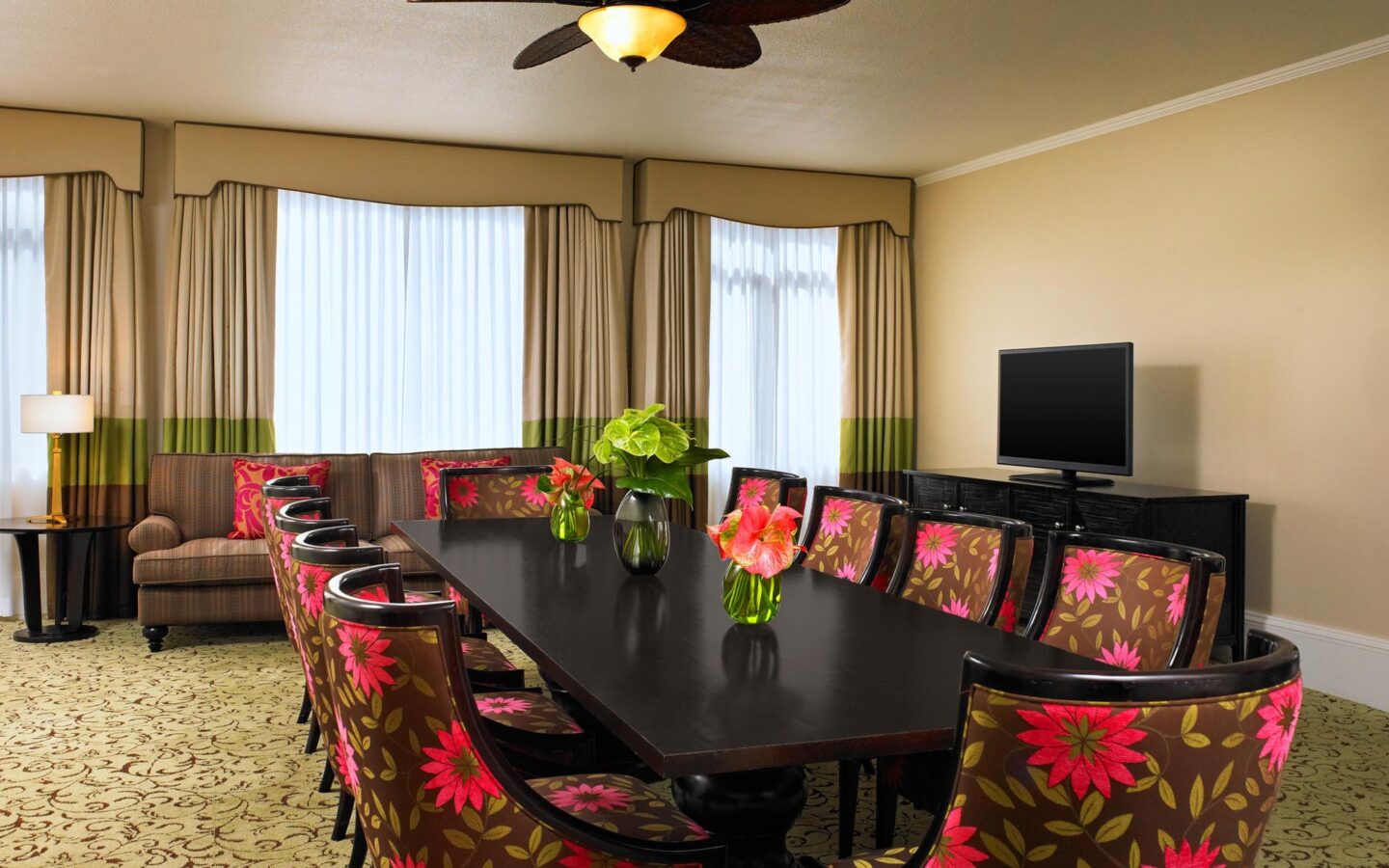 brown-and-pink floral padded chairs around long table