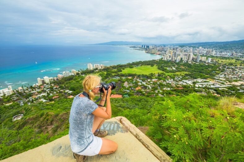 woman holding DSLR camera taking photo from top diamond head