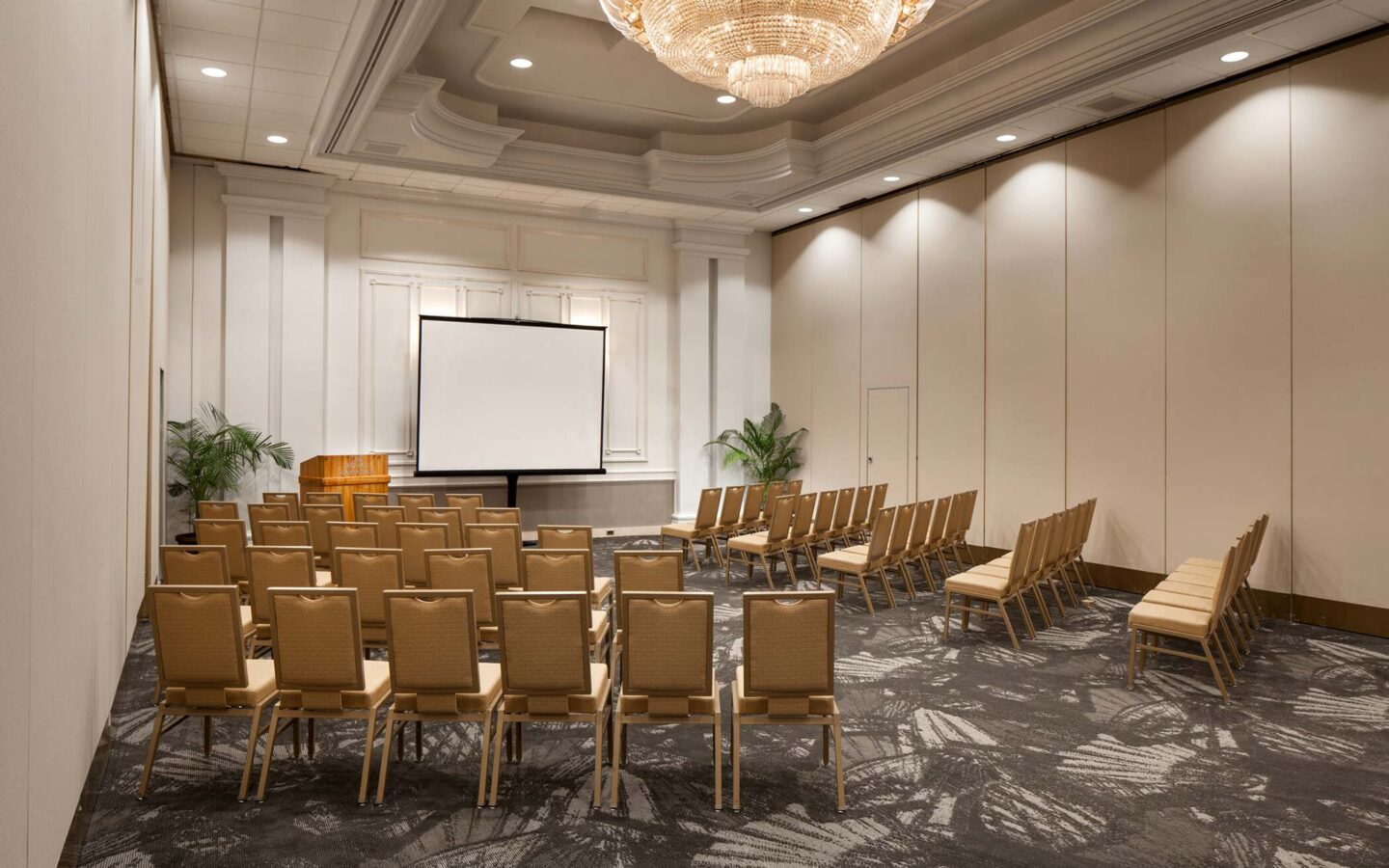 lot of beige chairs near screen projector