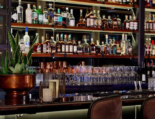 an indoor roof top bar with dozens of bottles