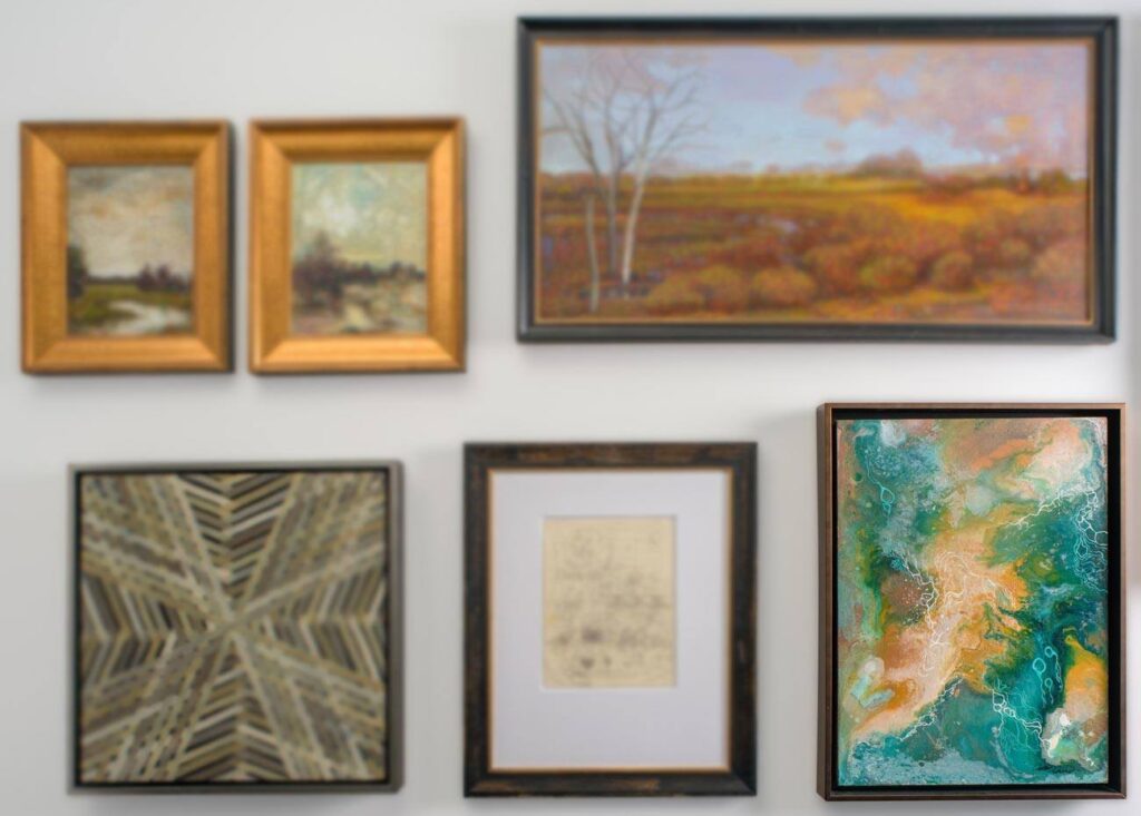 paintings displayed on a white wall