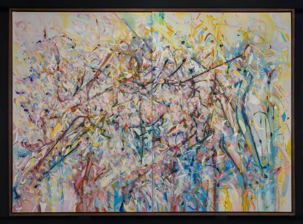 colourful painting in a brown frame