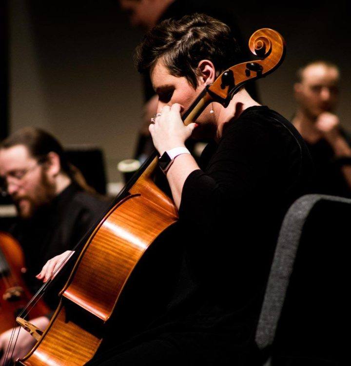 man playing violin during performance