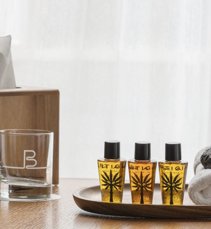 shower toiletries next to an empty glass and tissue box