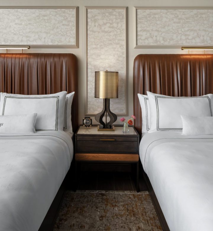 guest room with two beds and a nightstand between them