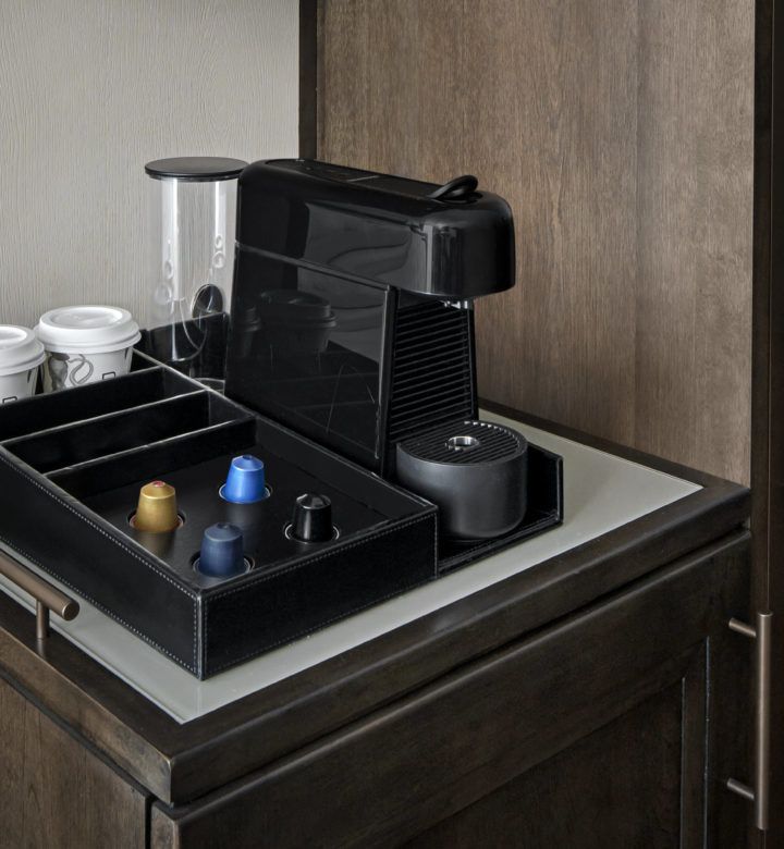 black coffee maker on brown wooden table