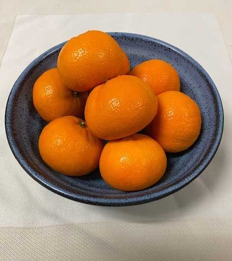 orange fruits on black round plate