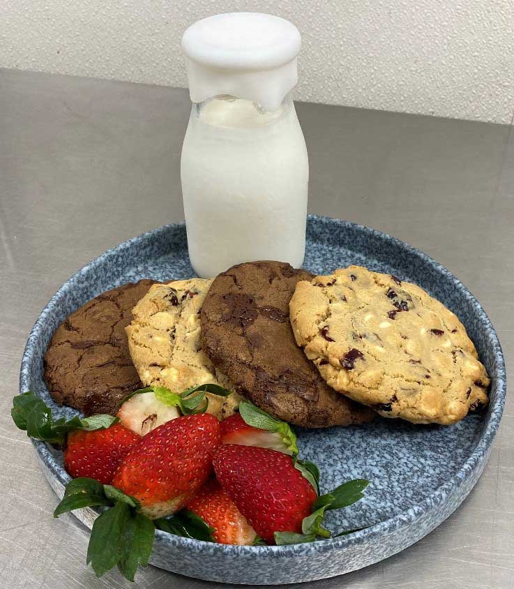 fried food with sliced strawberries on blue ceramic plate