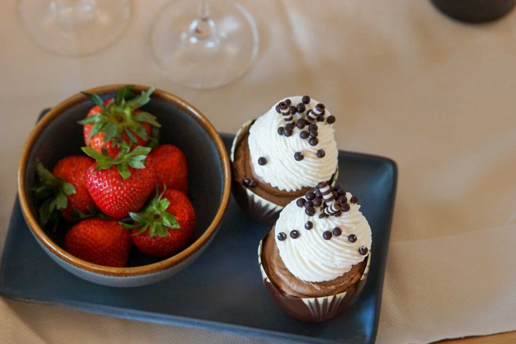 2 cupcakes with strawberries on top