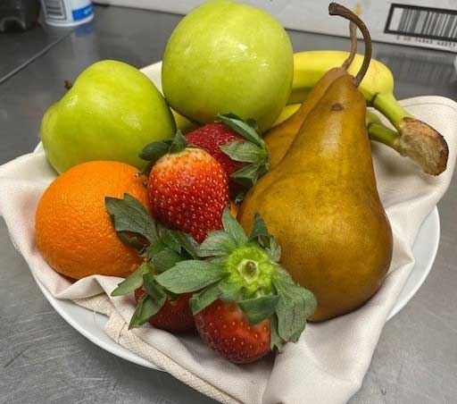 green apple and strawberry on white ceramic plate