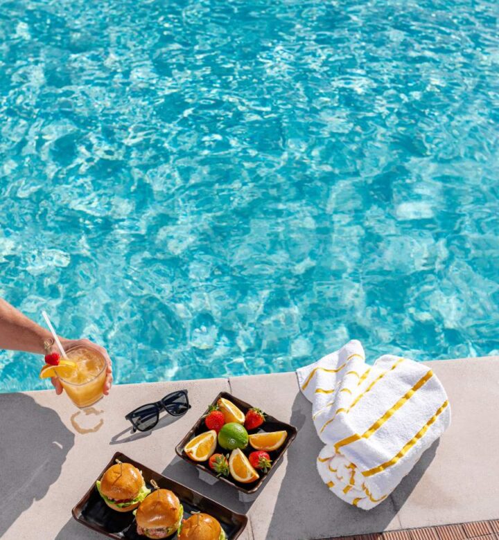 person in swimming pool with fruits