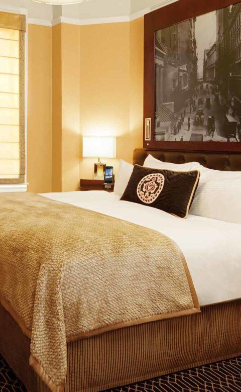 king bedroom set and single arm chair in the corner of the guest room