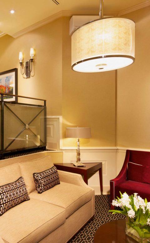 turned-on pendant lamp above love seat sitting area