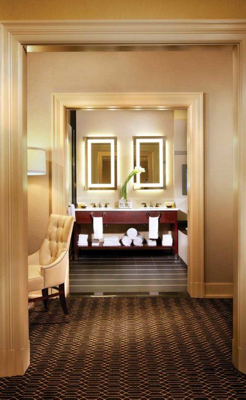 look through archways leading to the bathroom double sinks in the Barrymore Suite