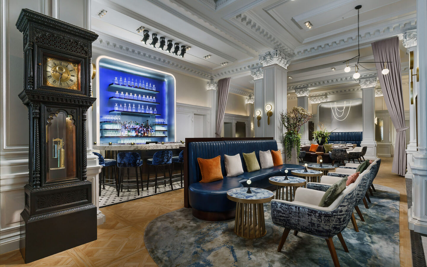a hotel lobby bar with high ceilings and an antique grandfather clock