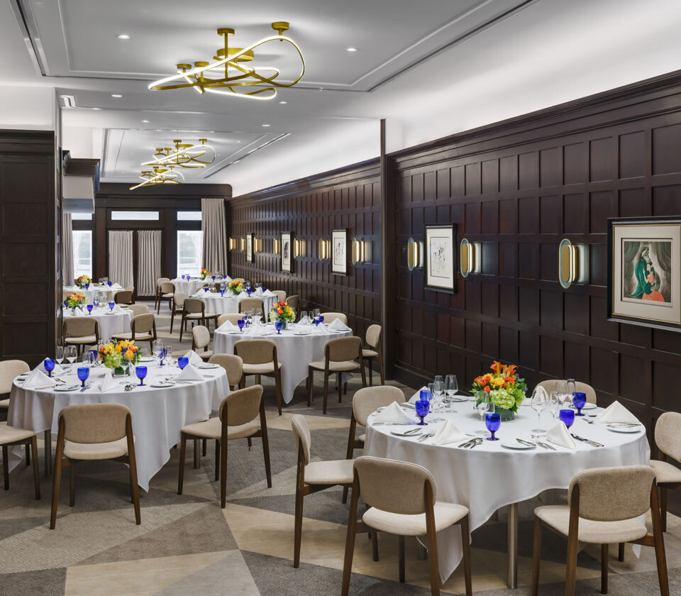 a dining room with tables and chairs and a chandelier
