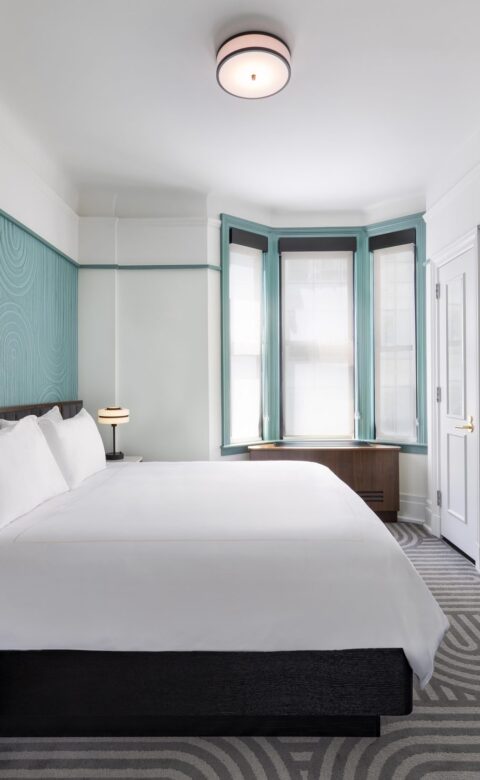 white bed linen on bed