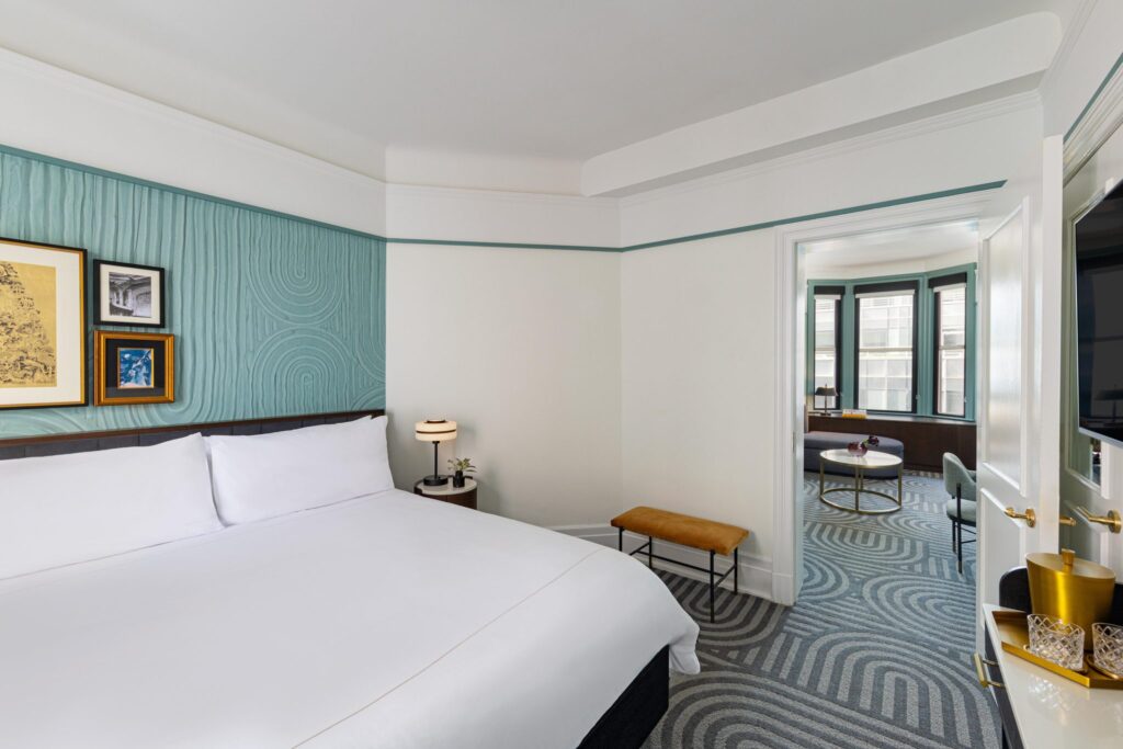 white bed linen near brown wooden chair