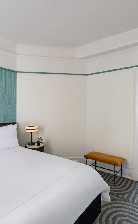 white bed linen near brown wooden chair