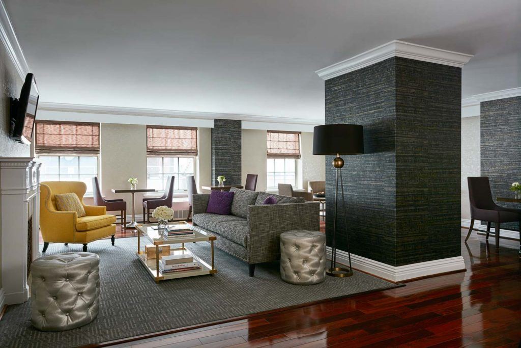 living room space with couches, decorative accents, television and dining area