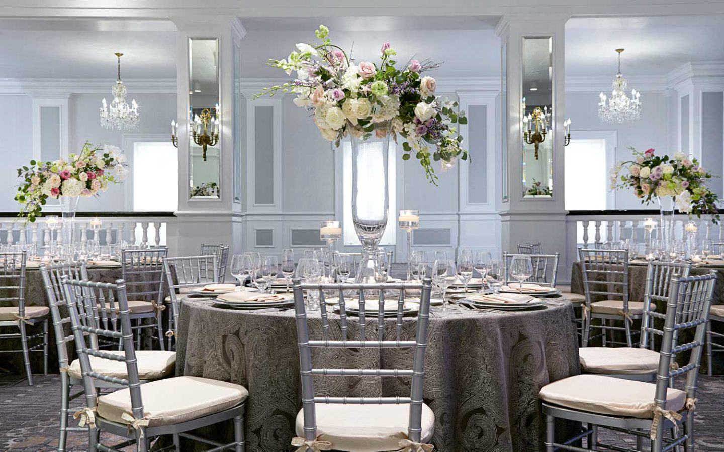interior of an event venue within a ballroom with flower centrepieces