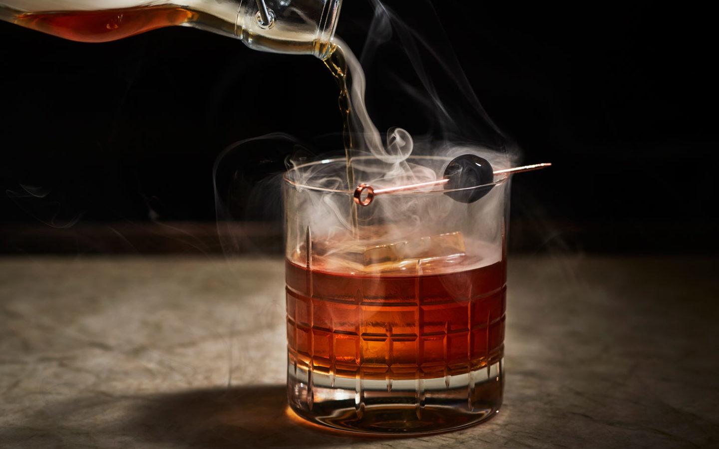 cocktail with pouring smoke as garnish