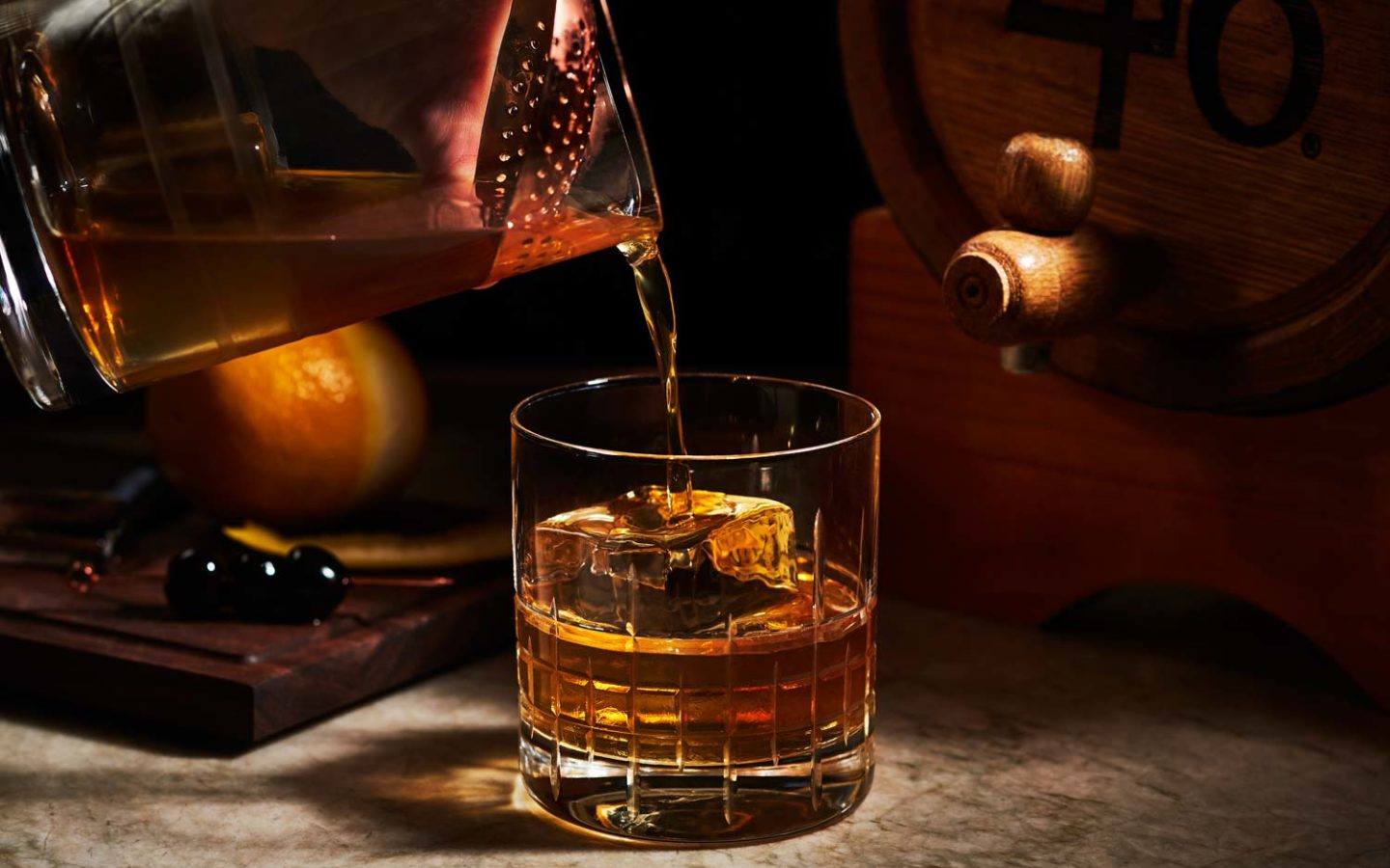 bartender pouring cocktail into glass
