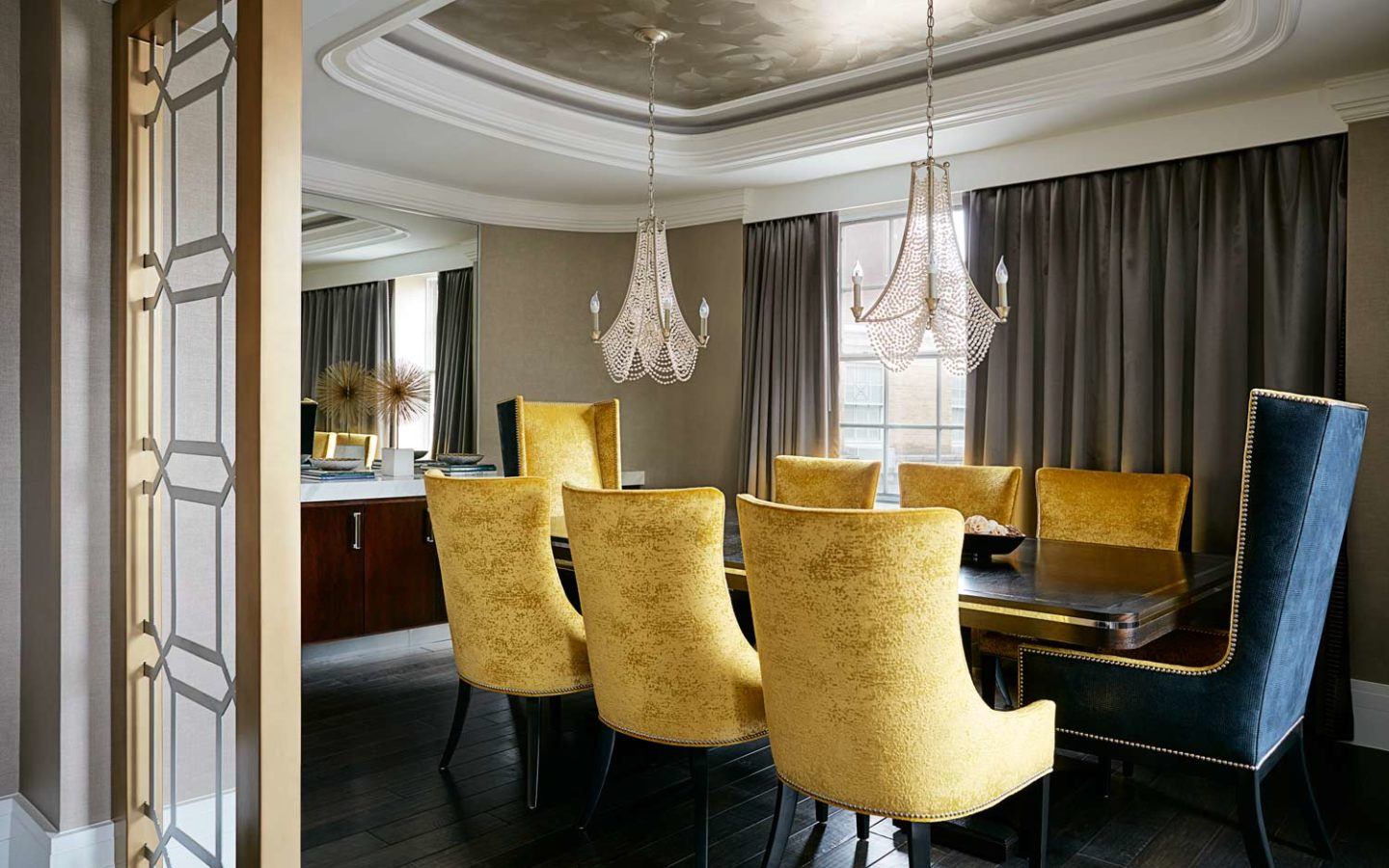 brown wooden table with large yellow armchairs