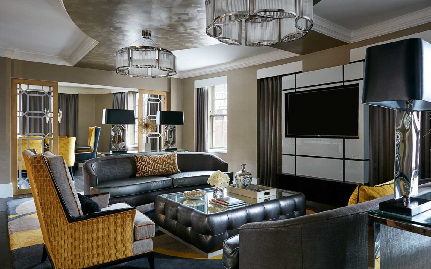 turned-off black flat screen TV on wall infront of leather living room seating