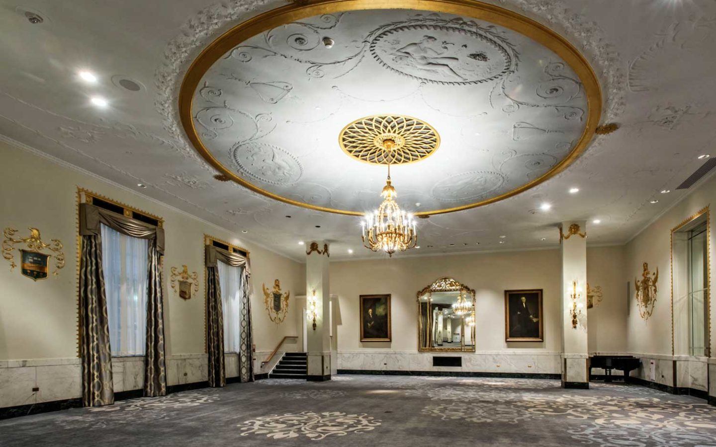 white and gold uplight chandelier in empty venue space
