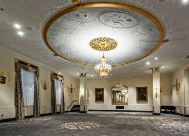 white and gold uplight chandelier in empty venue space