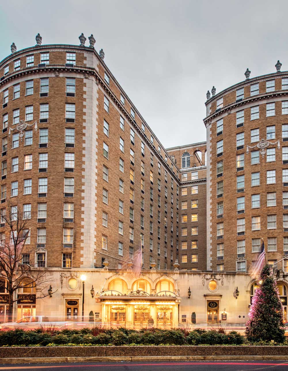the grand exterior of The Mayflower Hotel brightly lit up