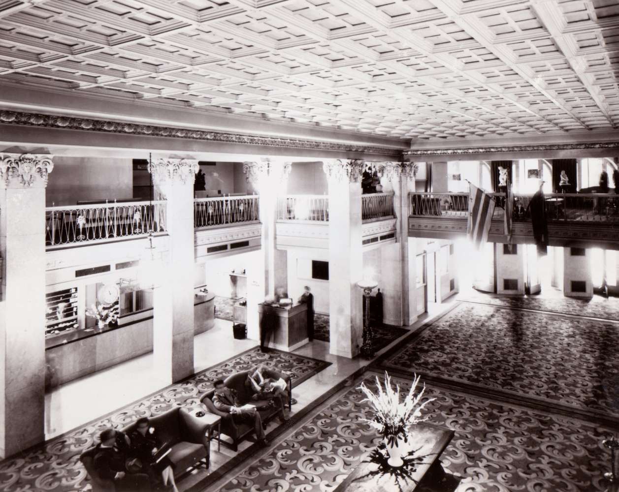 a black and white photo of an hotel lobby