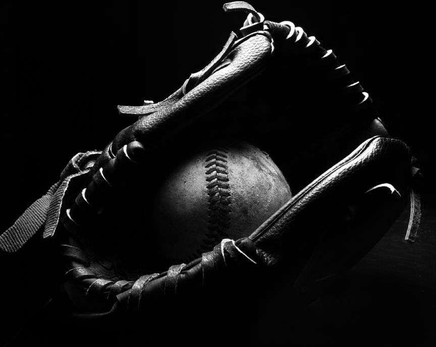 baseball nestled inside a baseball glove