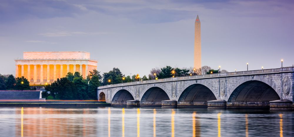 a bridge over a body of water with a building in the background