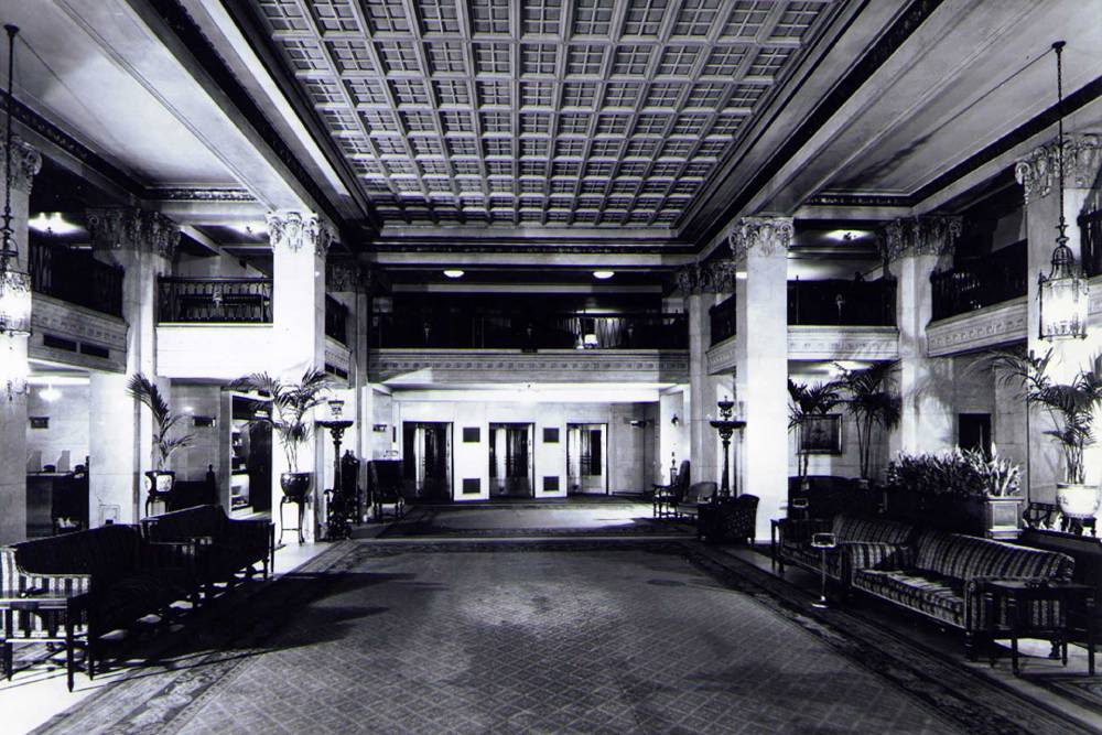 a black and white photo of an hotel lobby
