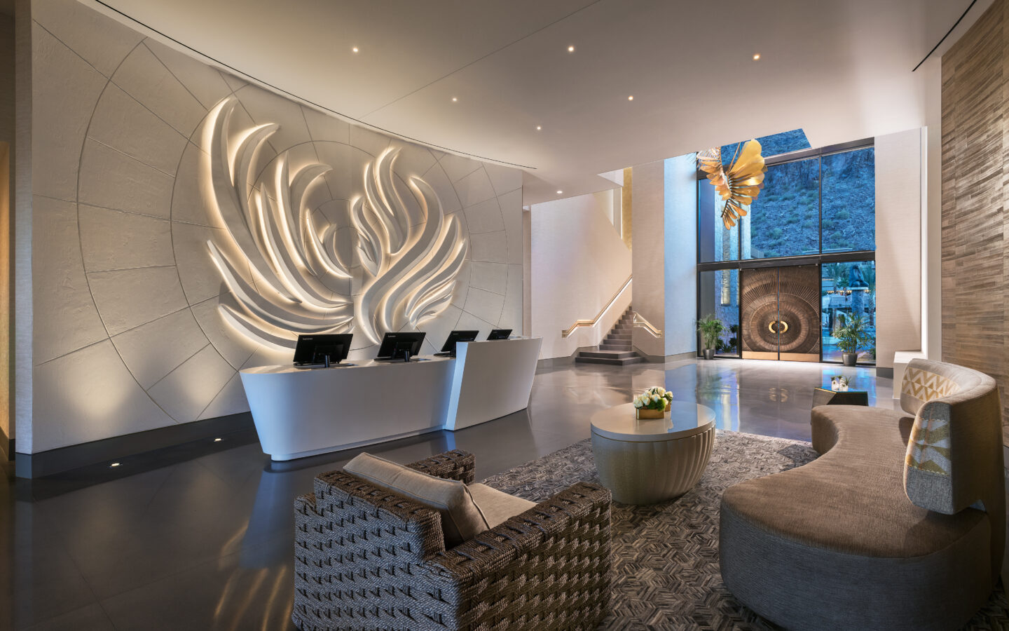 a modern lobby with a large motif on the wall