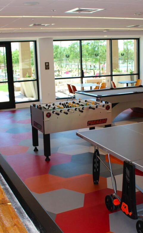 inside the games room at The Phoenician full of ping pong, arcade games and foosball tables