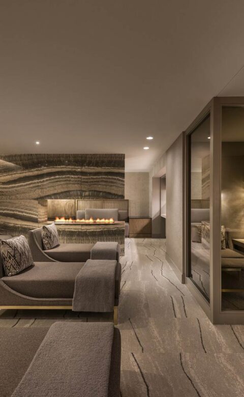 a row of daybeds in a comfortable and dimly lit spa post-treatment room