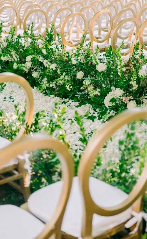 Gold chairs and romantic florals for ceremony set-up