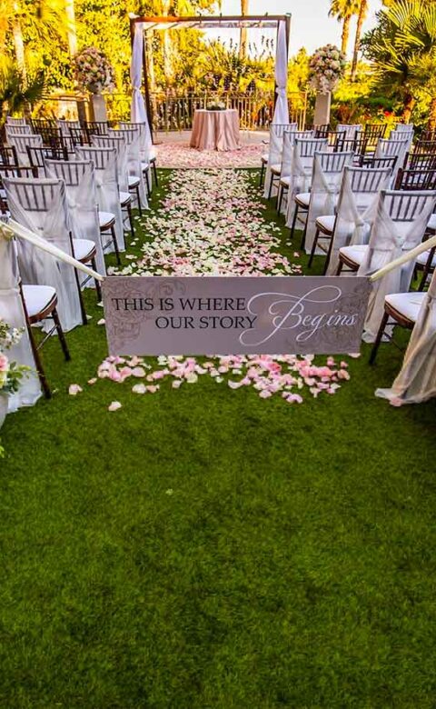 An enchanting ceremony set-up with cream and pink floral arrangements