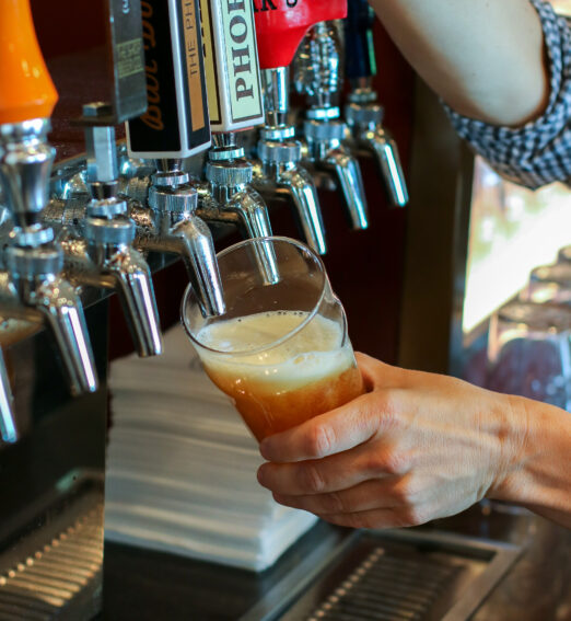 a man pouring a draught beer
