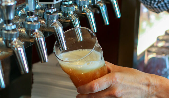 a man pouring a draught beer