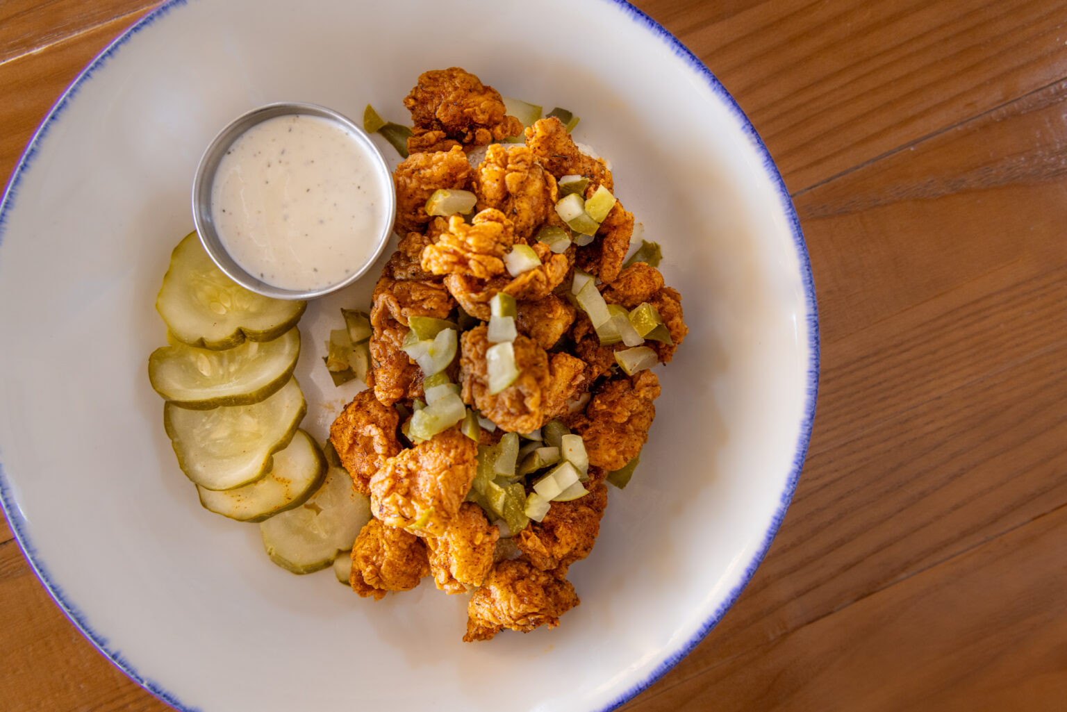 deep fried fish served with tartare sauce and pickled dill
