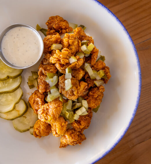deep fried fish served with tartare sauce and pickled dill