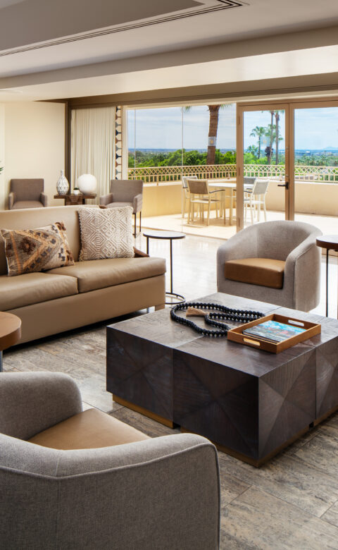 a living room filled with furniture and a large window