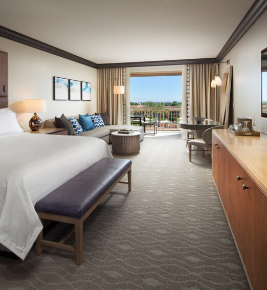 a bedroom with a large bed and a large window